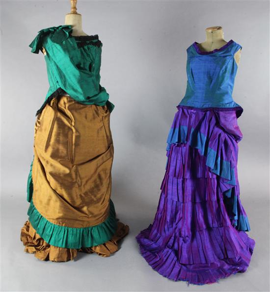 The Merry Widow: A rail with a purple and green dress, two similar dresses in green and brown and gold and